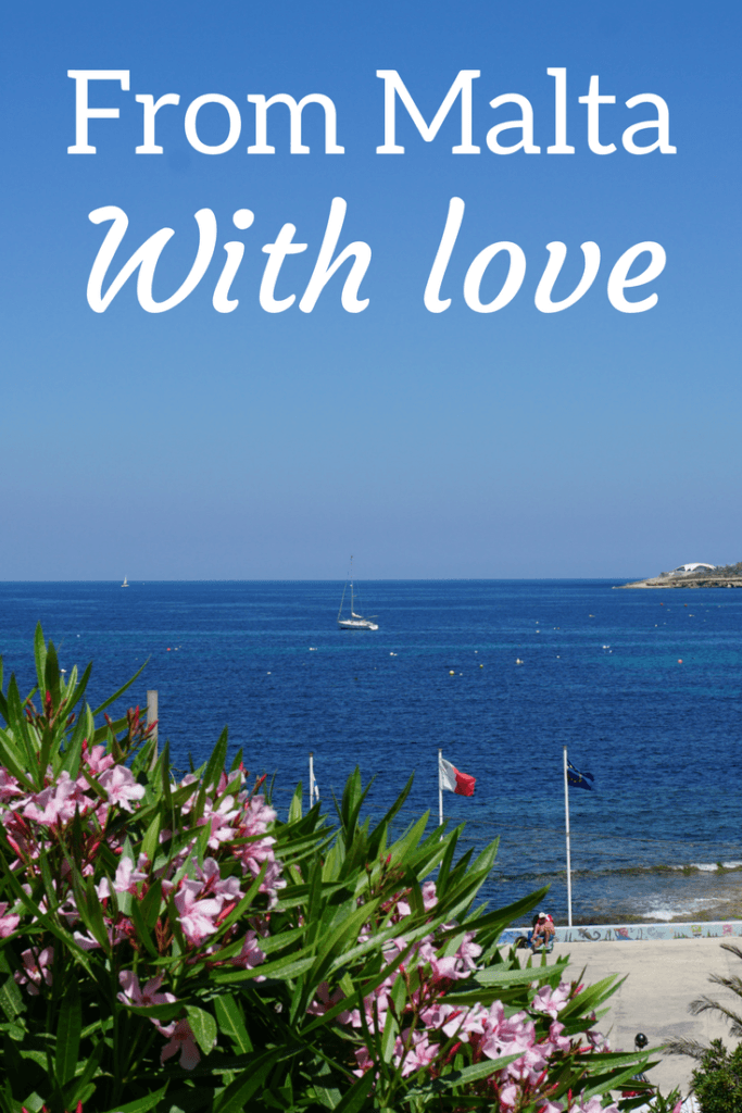 A view of the Mediterranean with Malta's flag and the EU flag on the coastline.