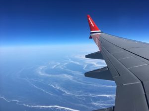 plane wing against a blue sky