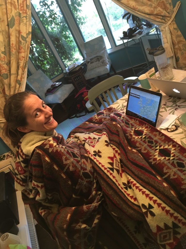 American expat blogger Amanda Walkins working on her computer in a cold room