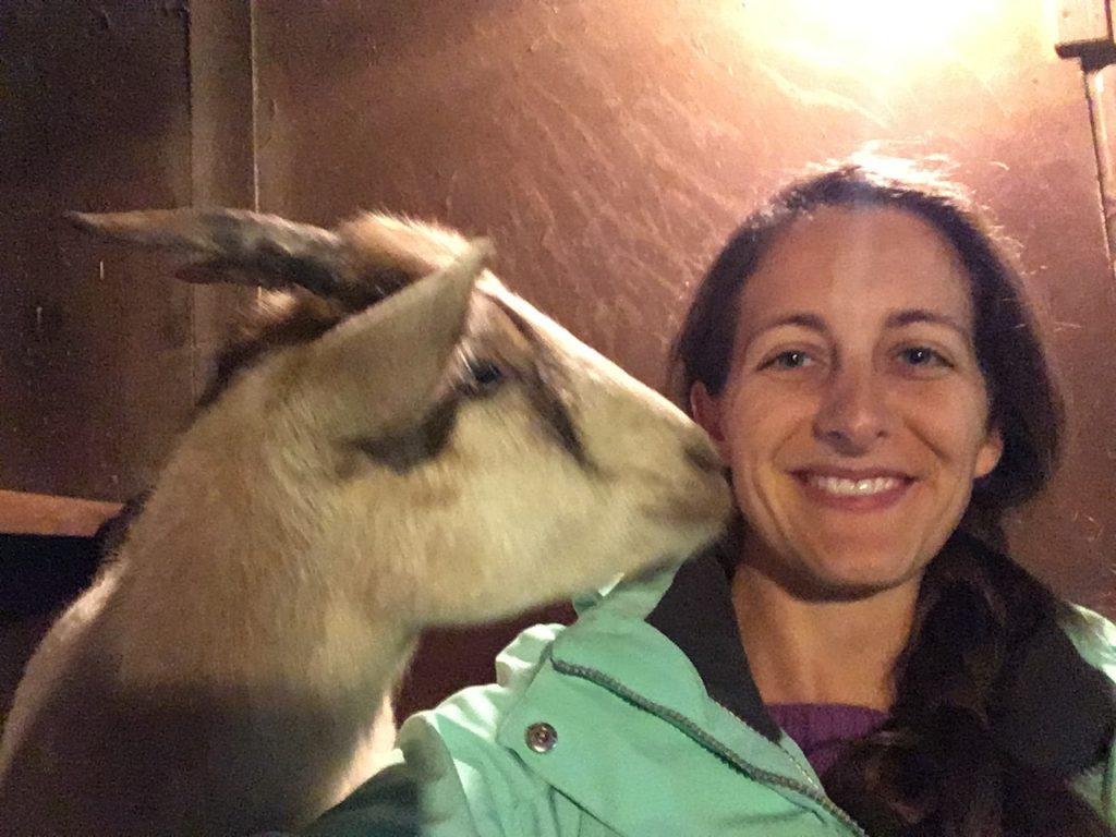 Amanda Walkins and Pan the goat cuddling