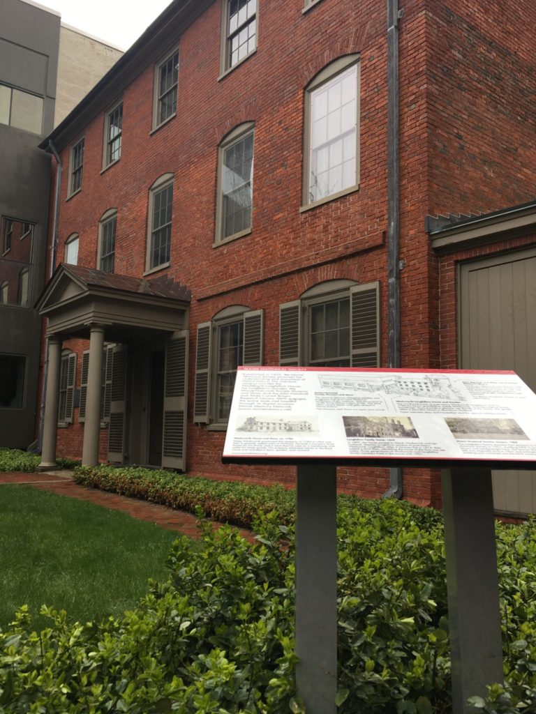 Henry Wadsworth Longfellow house with an informational panel out front in Portland ME