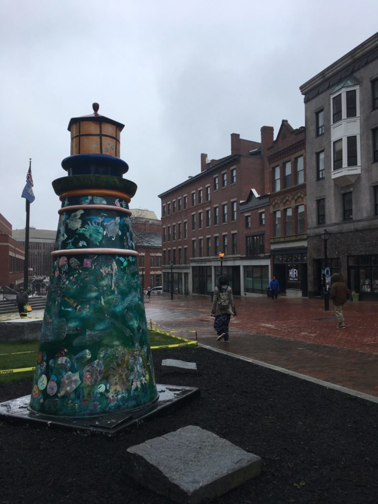 Small lighthouse statue in a pedestrian area of Portland Maine