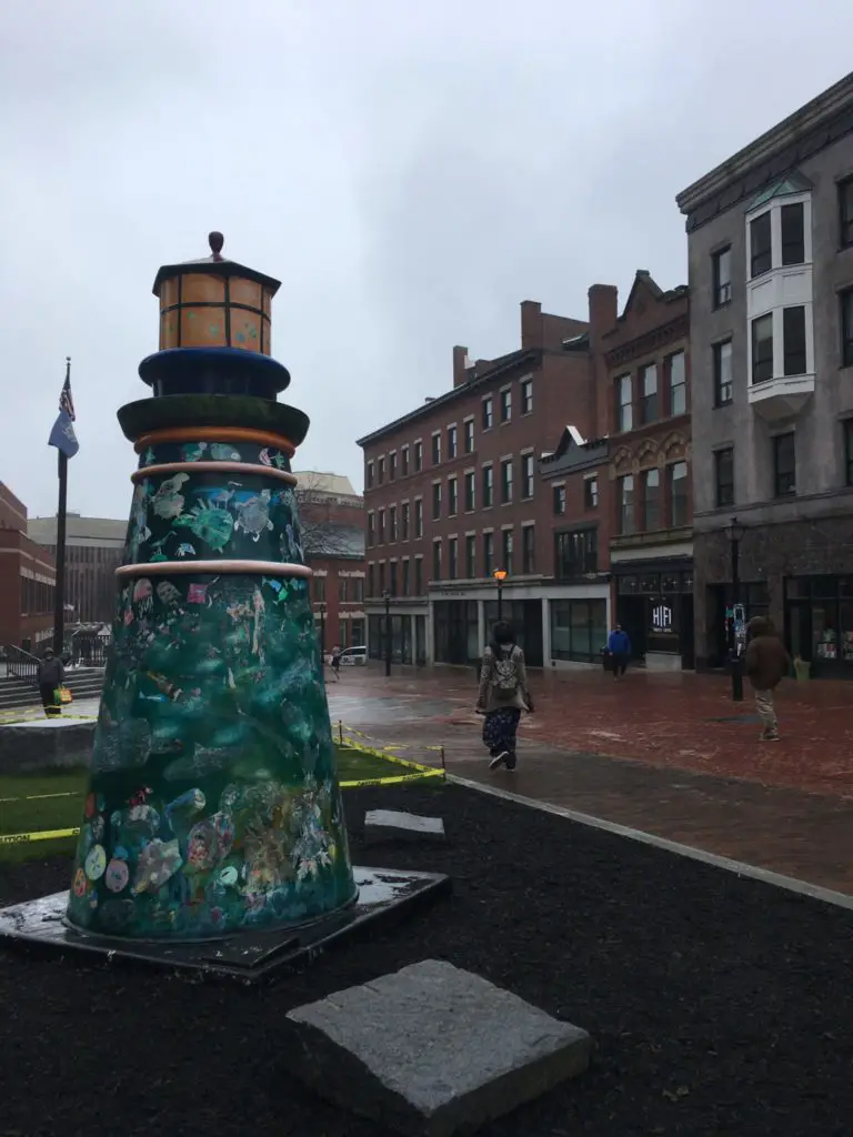 Small lighthouse statue in a pedestrian area of Portland Maine