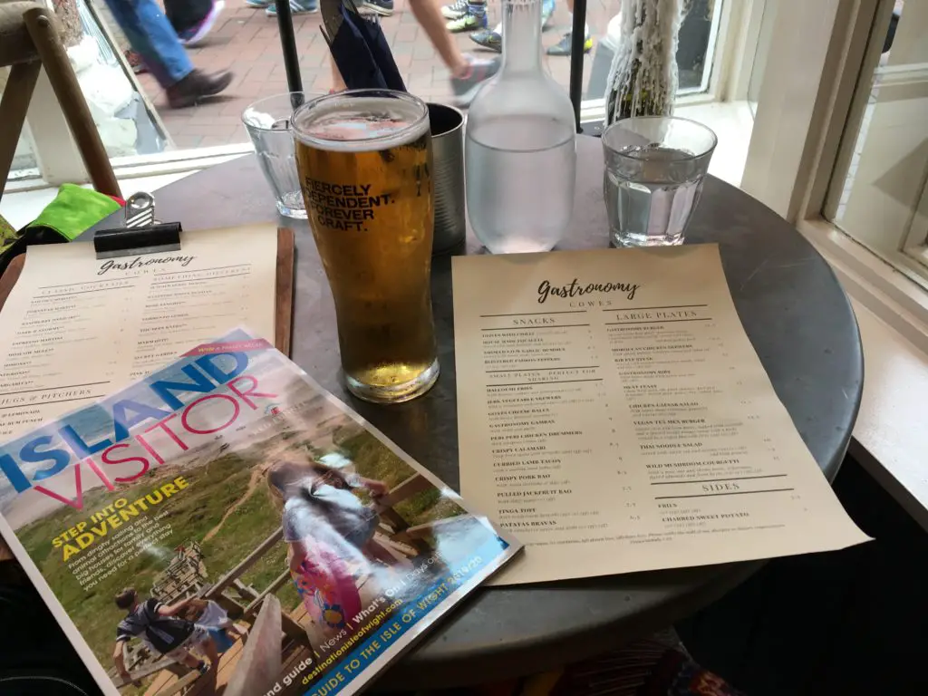 table setup at Gastronomy restaurant in Cowes on the Isle of Wight with Island Visitor magazine and a beer