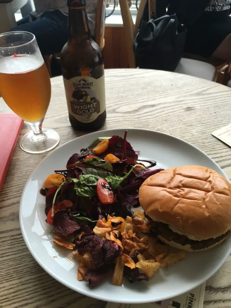Lunch at Piano Cafe on the Isle of Wight - glass of local beer with a vegetarian burger, chips, and a salad