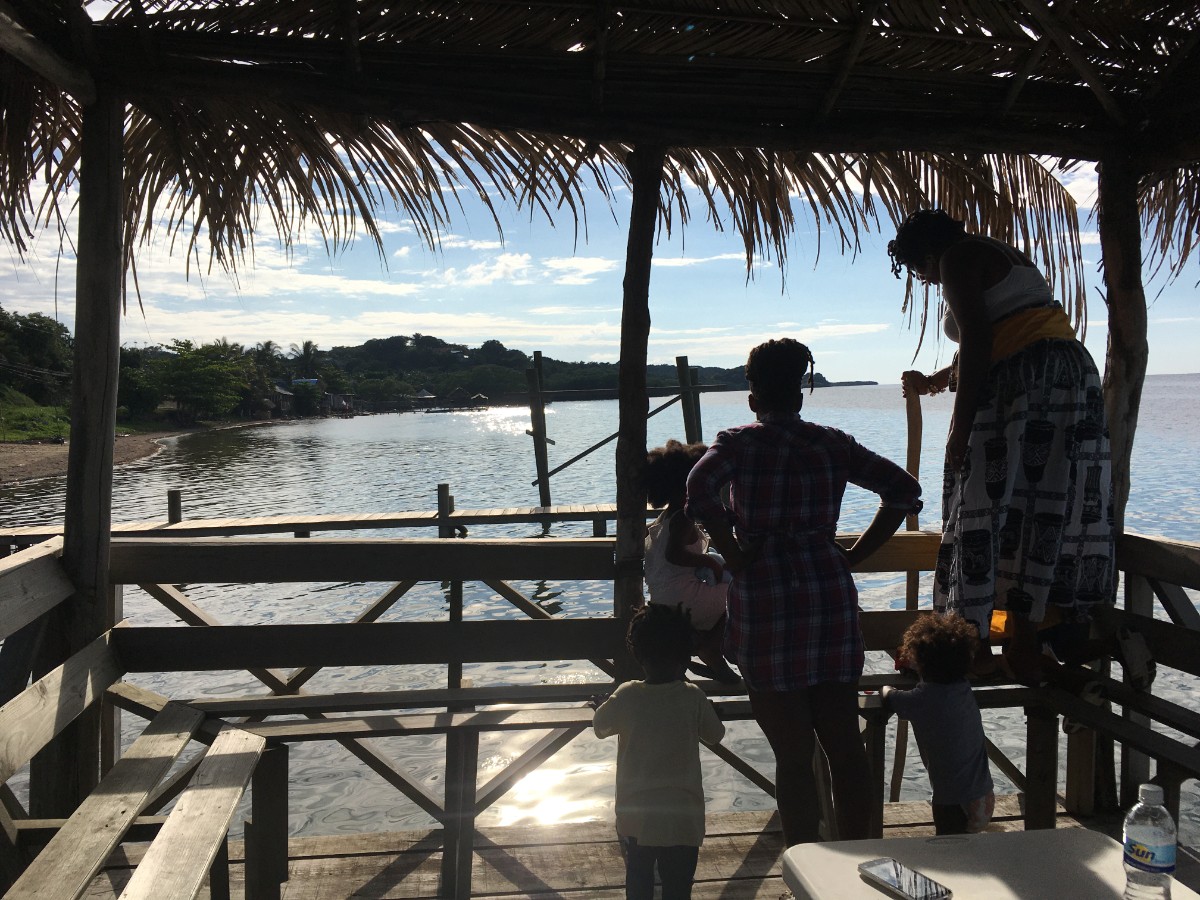 Backlit Flores family on the palapa in Punta Gorda