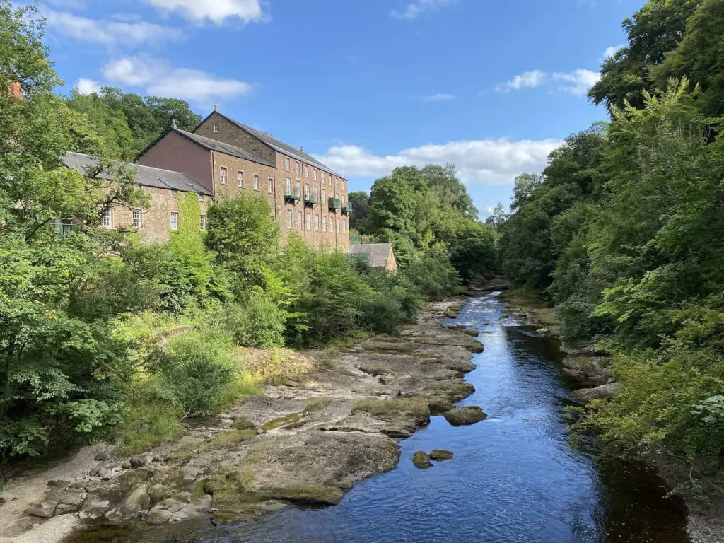 An old mill building rests along the river in Blairgowrie, Scotland